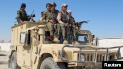 Afghan security forces arrive to fight off Taliban forces in the southern Helmand Province on October 21.