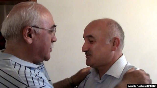 Musavat party deputy leader Arif Hajili (right) is greeted by an acquaintance in Baku after his release from prison on June 22.