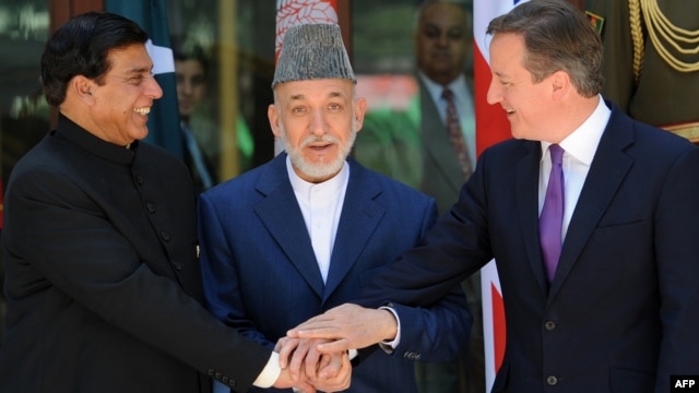 Afghan President Hamid Karzai (center), Pakistani Prime Minister Raja Pervez Ashfraf (left), and British Prime Minister David Cameron shake hands before a meeting at the Presidential Palace in Kabul on July 19.