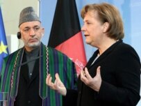 President Karzai (left) with Chancellor Merkel today (epa)
