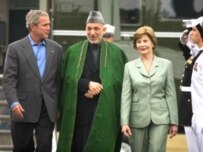 Hamid Karzai (middle) being greeted by George and Laura Bush on August 5 (AFP)