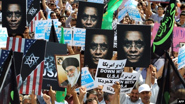 Iran -- Protestors  hold anti-US posters as they demonstrate after Friday prayers against a film mocking Islam, in Tehran, 14Sep2012