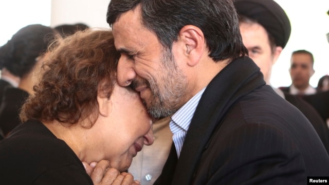Iranian President Mahmud Ahmadinejad offers his condolences to Elena Frias, mother of Venezuela's late President Hugo Chavez, during the funeral service at the Military Academy in Caracas on March 8.