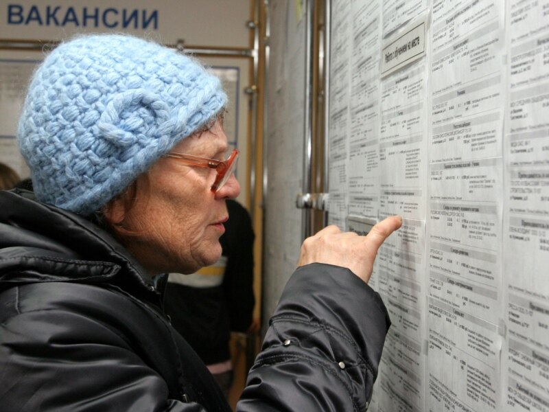 A woman looks at job listings in Kemerovo during a job fair in