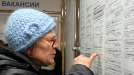 A woman looks at job listings in Kemerovo during a job fair in November.
