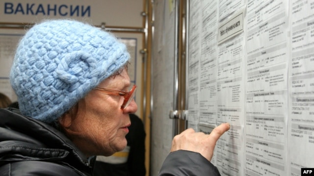 A woman looks at job listings in Kemerovo during a job fair in November.