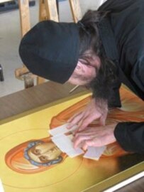 Brother Eugene, an icon painter, at work (RFE/RL)