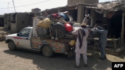 People pack belongings into a van in Miranshah in the North Waziristan tribal agency on June 13. More than 50,000 residents have reportedly fled their homes in the region.