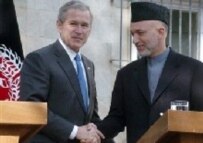 U.S. President George W. Bush (left) shakes hands with Afghan President Hamid Karzai in Kabul this March (AFP)