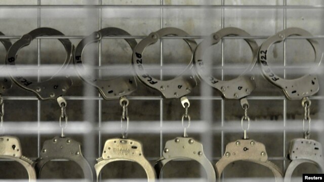 Handcuffs hang in the U.S. detention facility at Guantanamo Bay.
