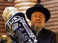 Chief Rabbi Israel Meir Lau carries the Torah into the synagogue of the new Jewish community center in Berlin during its official opening earlier this month (AFP)
