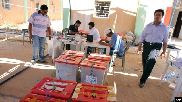 Libyan High Election Commission workers set ballot boxes from different polling stations as they prepare for the final counting in Benghazi on July 8.