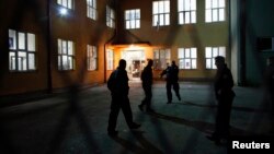 Kosova police secure the area in front of a polling station in the ethnically divided Kosovo town of Mitrovica, where voting was marred by outbreaks of violence.