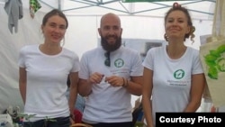 Tatyana Zaugolnova (left, at a makeup stand at a festival with her employees) fears she'll have to close her shop..