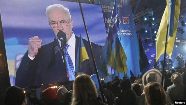 Supporters of the pro-presidential Party of Regions listen to Ukrainian Prime Minister Mykola Azarov speak as they attend a preelection rally in Kyiv on October 26.