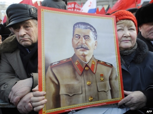 Russian Communist Party supporters hold a portrait of Soviet leader  Josef Stalin at rally in Moscow in February.