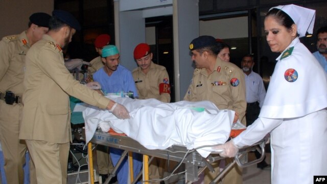 A Pakistani Army medical team transports Malala Yousafzai from a military hospital in Rawalpindi to an air ambulance on October 15, when she was transported to the United Kingdom.