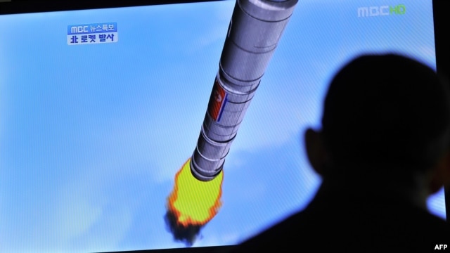 A TV shows a graphic of North Korea's rocket launch at a train station in Seoul in April
