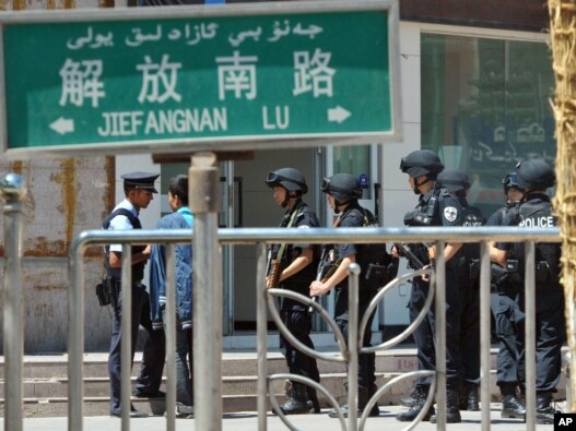 Chinese Special Police Corps troops stand guard near the site of an attack in Kashgar in Xinjiang in August 2011 that was blamed on Islamic extremists.