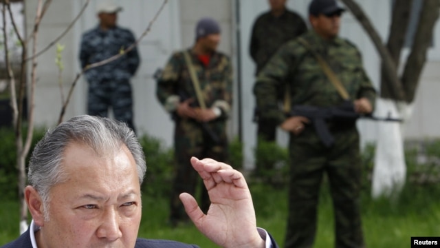 Ousted Kyrgyz President Kurmanbek Bakiev speaks to reporters in Teyit on April 13.