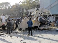 Afghan officials and soldiers investigating the bomb site (AFP)