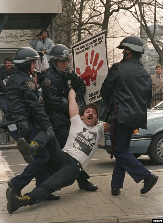 New York police arrest one of several dozen demonstrators who blocked streets by city hall to protest Mayor Ed Koch's AIDS policies on March 28, 1989.