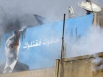 Smoke billows from a pro-government television station after Hizbollah gunmen seized control of western Beirut (AFP)