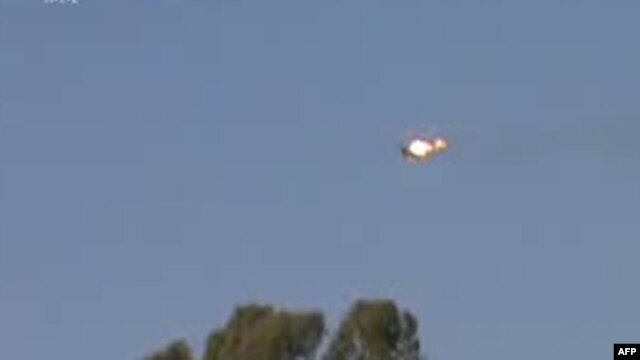 A video grab allegedly shows a Syrian jet fighter on fire after being hit by rebel fire over a village near the eastern city of Deir el-Zour on August 13.