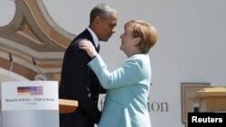 U.S. President Barack Obama (left) and German Chancellor Angela Merkel embrace after delivering remarks in the Bavarian village of Krun on June 7.