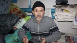 Azimjan Askarov speaks to a reporter in his prison cell.