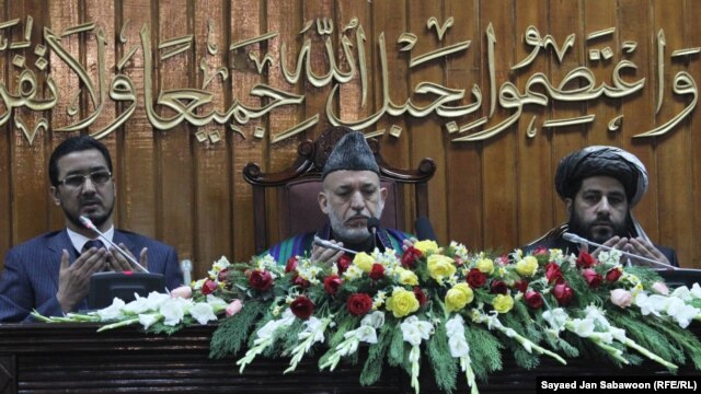Afghan President Hamid Karzai (center), seen praying during the opening ceremony of the second year of the Afghanistan parliament in January, was said to be angered by the Qatar initiative.