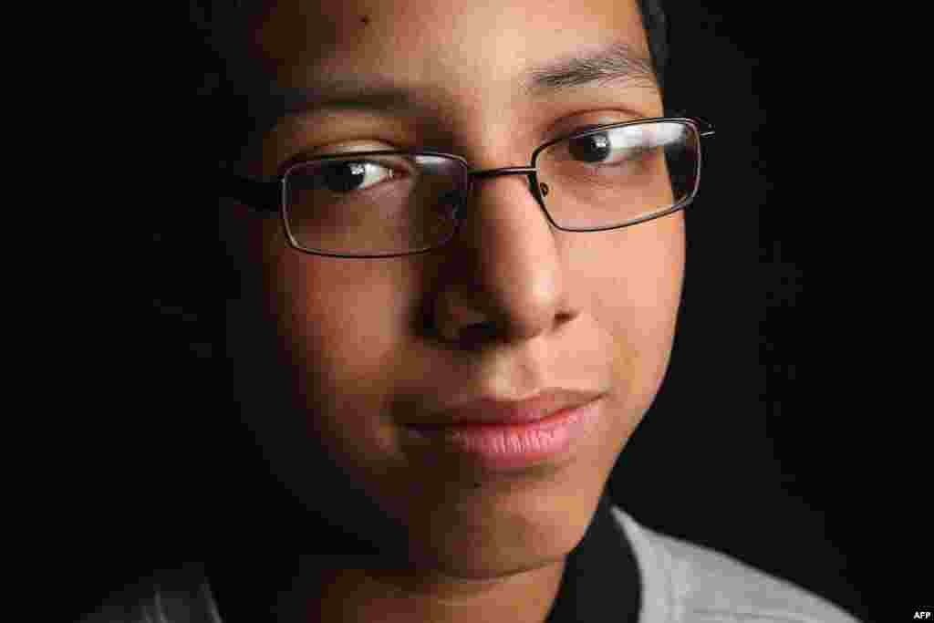 Eighth-grade student Carlos Hernandez, 13, was born in Peru. His mother, Sisi Hernandez, is a domestic worker. The family lives in Queens, New York City.
