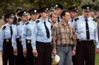 Georgian police escort the detained Russians in the handover in Tbilisi on October 2 (epa)