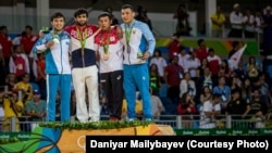 Чемпион Олимпиады российский дзюдоист Беслан Мудранов (второй слева) и серебряный призер казахстанец Елдос Сметов (слева) на пьедестале. Рио, 6 августа 2016 года.