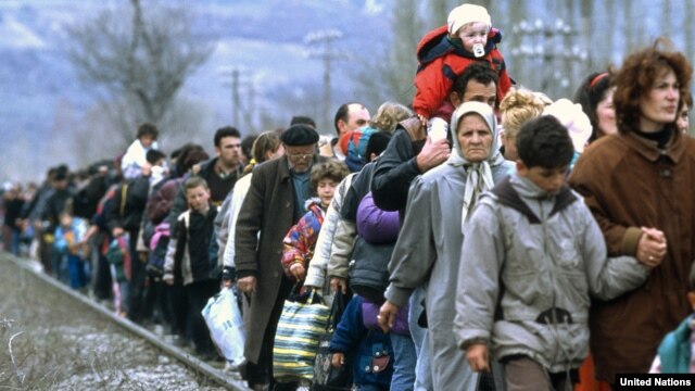 Kosovar refugees flee across the border into Macedonia in March 1999.