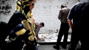 People in the capital, Tehran, reading newspapers the day the shortlist of presidential candidates for the June 14 election was announced.