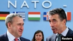 Ukrainian Foreign Minister Andriy Deshchytsya (left) listens to NATO Secretary-General Anders Fogh Rasmussen during a NATO-Ukraine foreign ministers meeting in Brussels on April 1.
