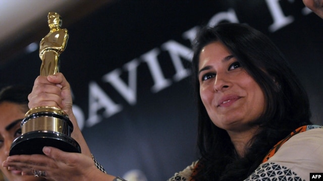 Pakistani director Sharmeen Obaid-Chinoy poses for photographs with the Academy Award she won in 2012 for a documentary on acid attacks on Pakistani women. Her latest movie tackles the subject of 'honor killings' in Pakistan, which she says claims the lives of hundreds of women every year.