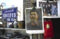A picture of Soviet dictator Josef Stalin hangs beside one of Chairman Mao in a small street market.