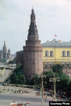 Looking into Moscow's Red Square, with St. Basil's Cathedral in the distance. Thousands of people can be seen standing in a long, snaking line to enter Lenin's mausoleum.