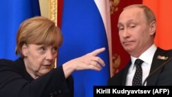 Lost in translation? German Chancellor Angela Merkel (left) gestures as Russian President Vladimir Putin looks on during the pair's joint press conference at the Kremlin in Moscow on May 10.