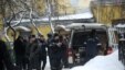 Russian police officers and investigators crowd at the site of the killing of Aslan Usoyan, better known as 