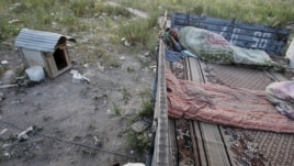 A migrant worker sleeps on top of a shelter outside Moscow.