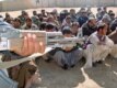 Afghan nationals brought to Pakistan's Chaman border-crossing for handover to Afghan authorities after their detention for traveling on false documents