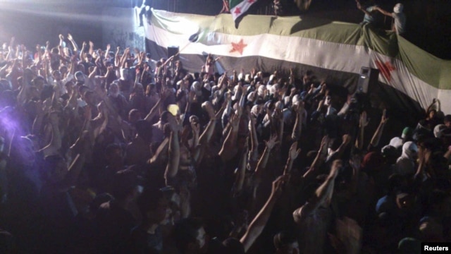 Demonstrators protest against Syria's President Bashar al-Assad at Kfr Suseh in Damascus on June 12.