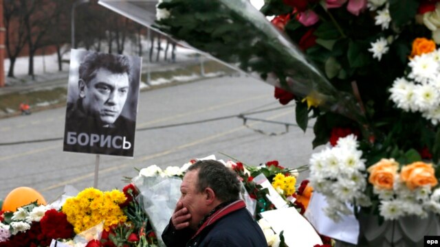 A man reacts at the site where veteran Russian opposition leader Boris Nemtsov was shot dead in central Moscow.
