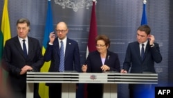 Lithuanian Prime Minister Algirdas Butkevicius (left to right), Ukranian Prime Minister Arseniy Yatsenyuk, Latvian Prime Minister Laimdota Straujuma, and Estonian Prime Minister Taavi Roivas speak to the press after their meeting in Riga on November 5.