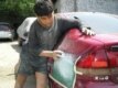 Another 15-year-old fixes a dent in a car in Almaty (RFE/RL)