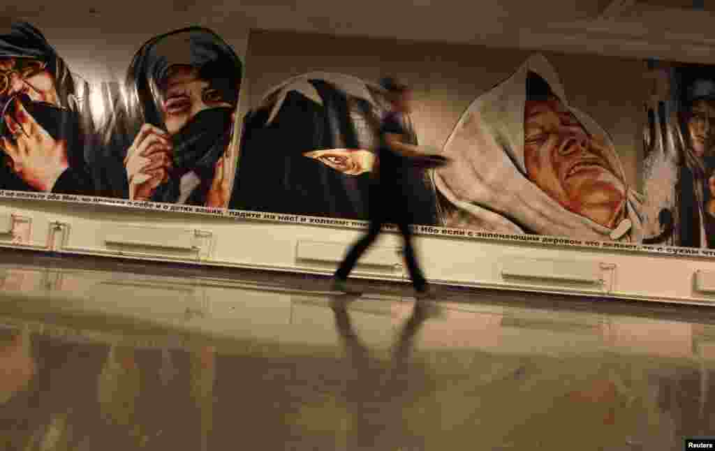 A visitor walks past an exhibit at the Icons exhibition of works by Russian artists curated by Marat Gelman at the Tkachi gallery in St. Petersburg. (Reuters/Alexander Demianchuk)