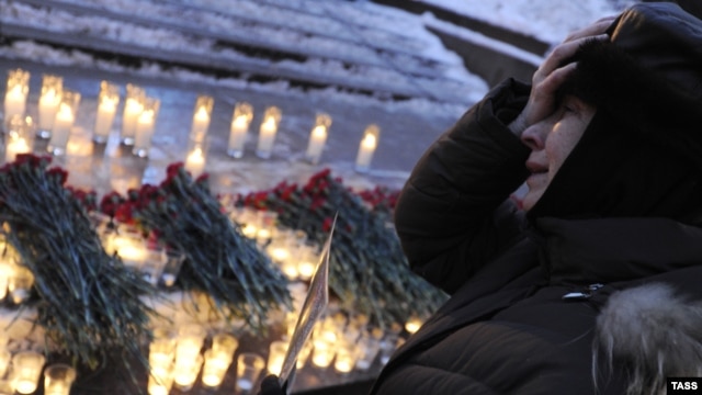 A woman mourns during a ceremony in central Moscow’s Pushkin Square for victims of the Domodedovo bombing in January 2011.